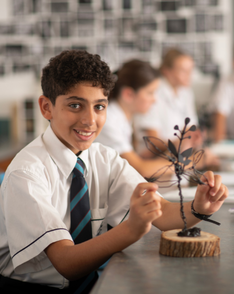 Student working on sculpture in Arts class